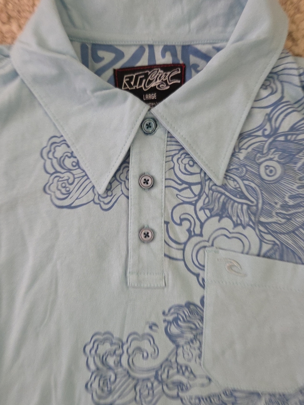 Rip Curl Light Blue Polo with Navy Wave Graphic, L